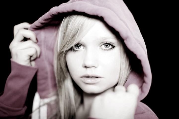 Ein Mädchen mit rosa Pullover und Kapuze